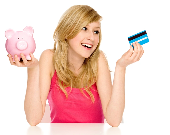 Smiling woman holding piggy bank and credit card representing cosmetic surgery finance and payment options.